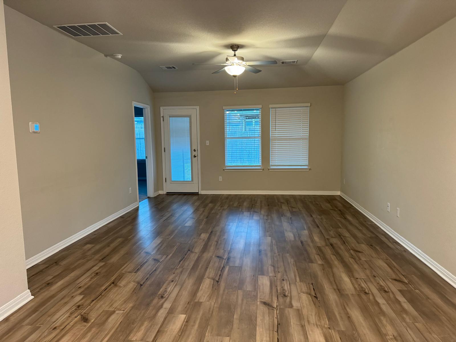 623 Sungrove Trail Georgetown, TX 78628 - Photo 5 of 17 Spare room featuring a ceiling fan, lofted ceiling, and dark wood finished floors