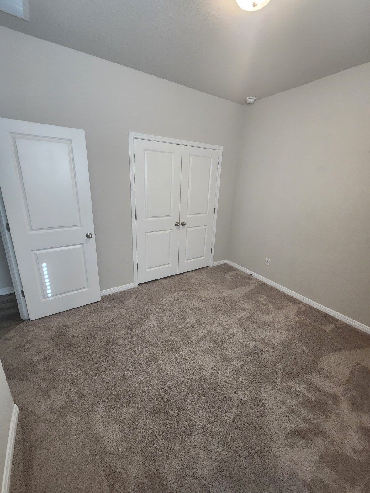 623 Sungrove Trail Georgetown, TX 78628 - Photo 8 of 17 Unfurnished bedroom with a closet and dark colored carpet