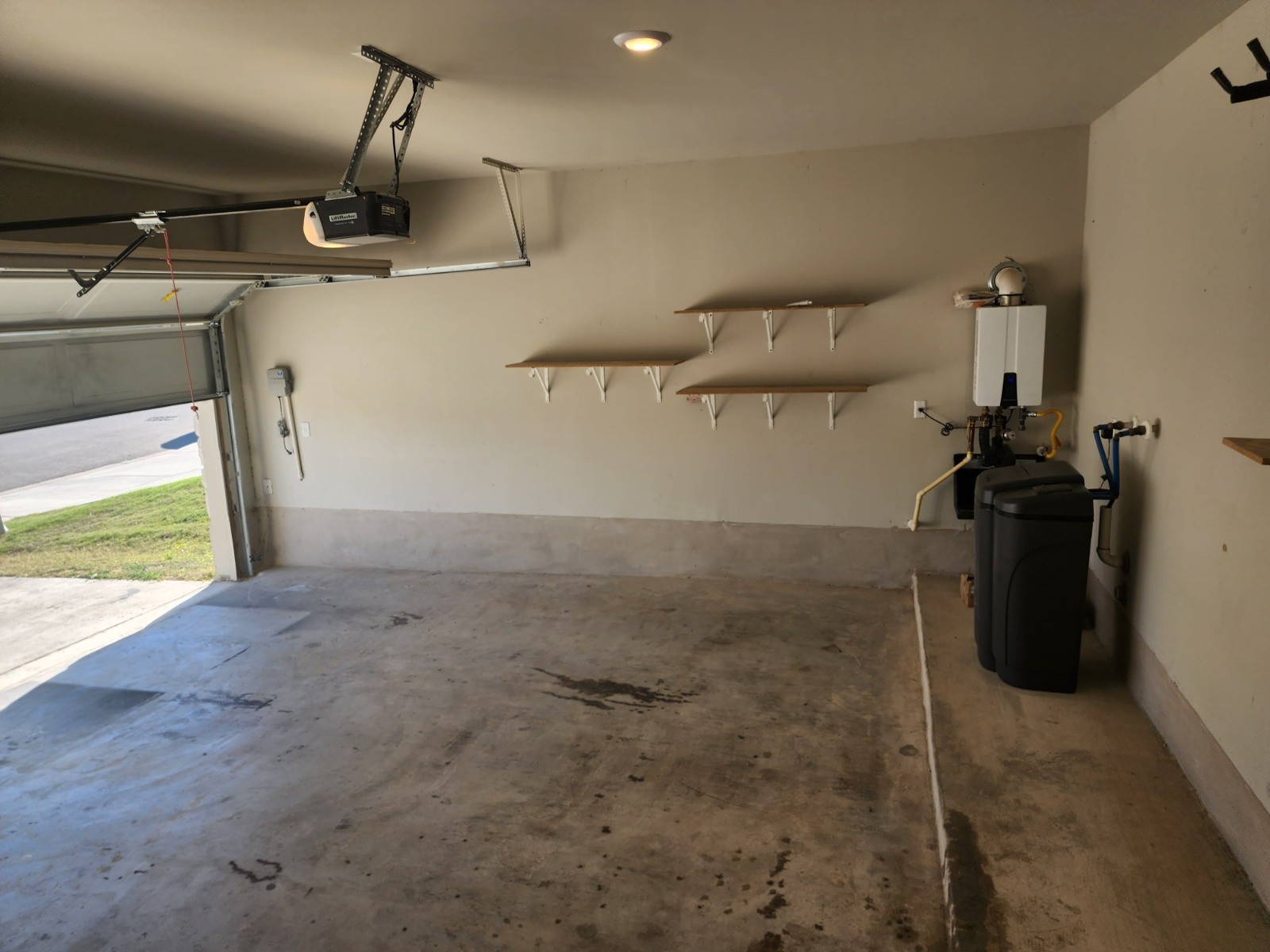 623 Sungrove Trail Georgetown, TX 78628 - Photo 9 of 17 Garage with a garage door opener and water heater