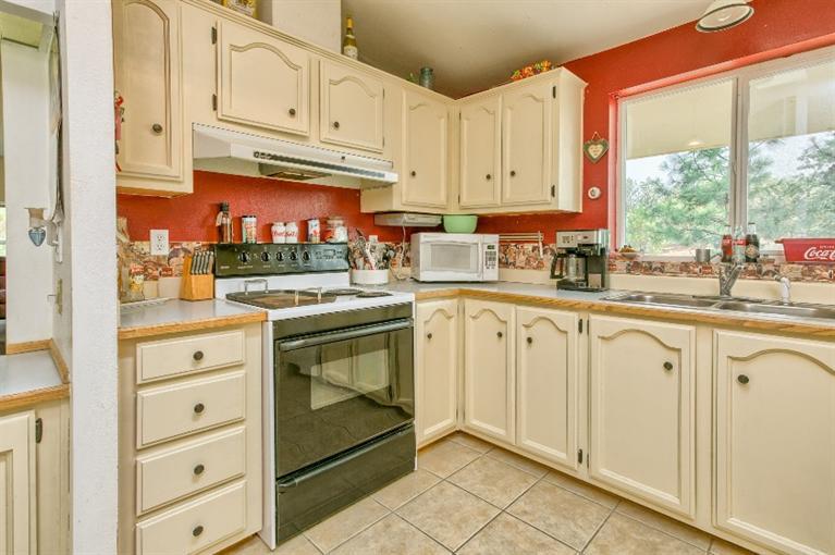 2388 Old Military Road Central Point, OR 97502 - Photo 21 of 35 a kitchen with white cabinets and white appliances