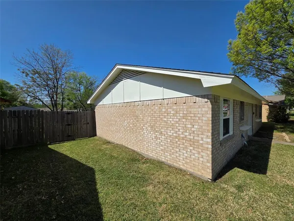 a view of backyard with small cabin