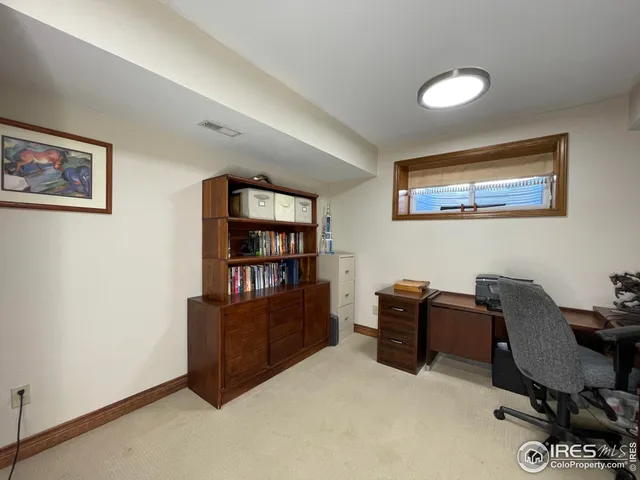 a view of workspace with lounge chair and cabinet
