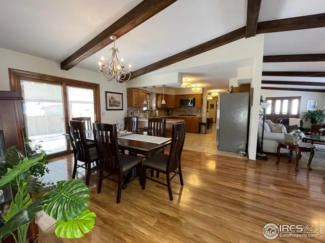 a dining room with furniture entryway and wooden floor