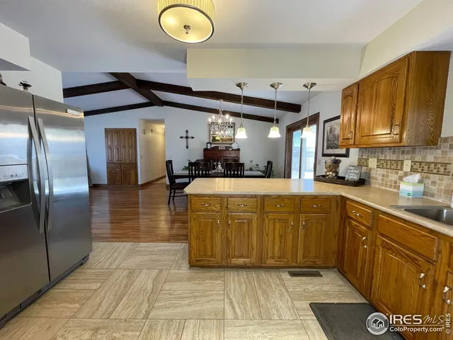 a kitchen with stainless steel appliances granite countertop a sink and a refrigerator