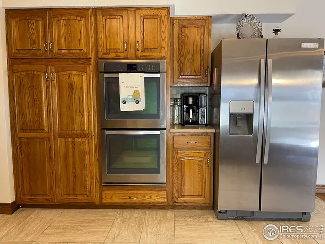 a kitchen with stainless steel appliances granite countertop a refrigerator and cabinets