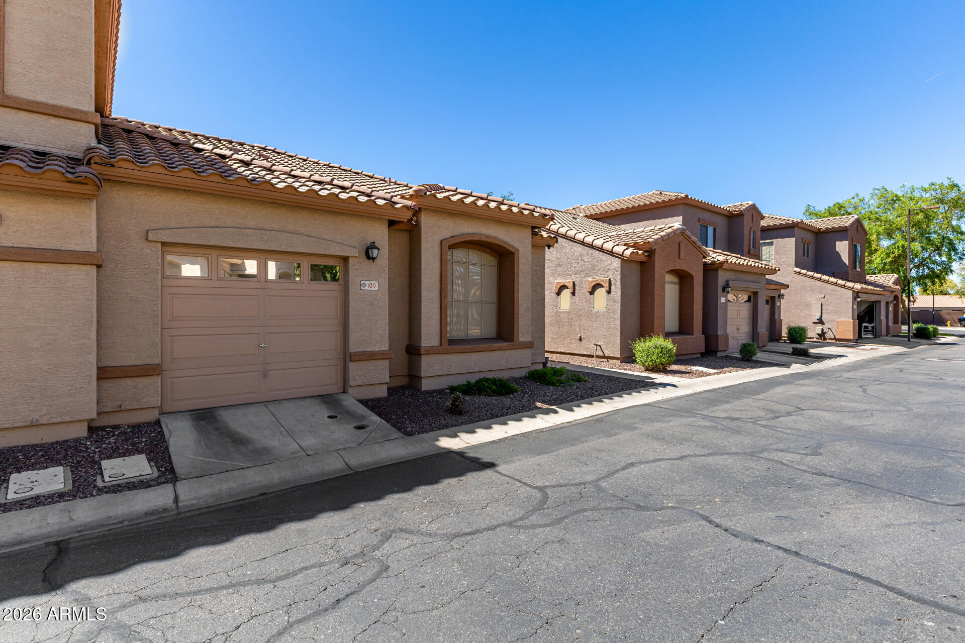 2600 East Springfield Place, Unit 109 Chandler, AZ 85286 - Photo 3 of 38 a front view of a house with a yard