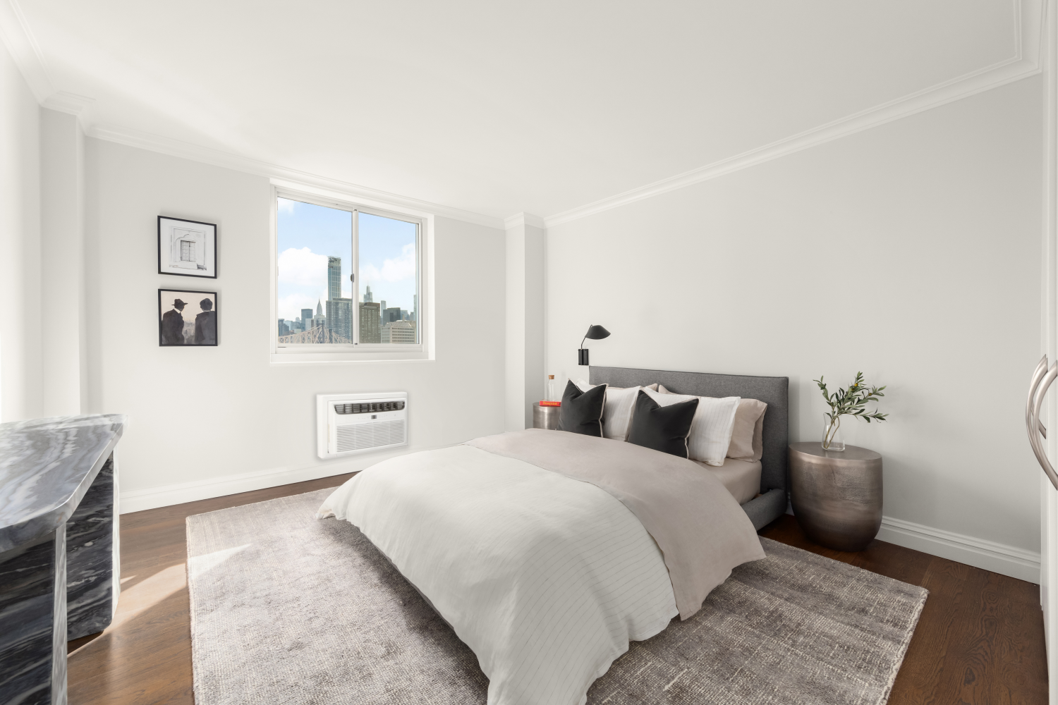 595 Main Street, Unit 309 Manhattan, NY 10044 - Photo 1 of 1 a bedroom with a large bed and a couch