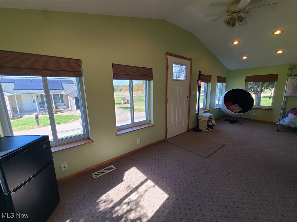 70 Davis Road Waterford, OH 45786 - Photo 6 of 16 Foyer entrance featuring a healthy amount of sunlight, carpet, and lofted ceiling