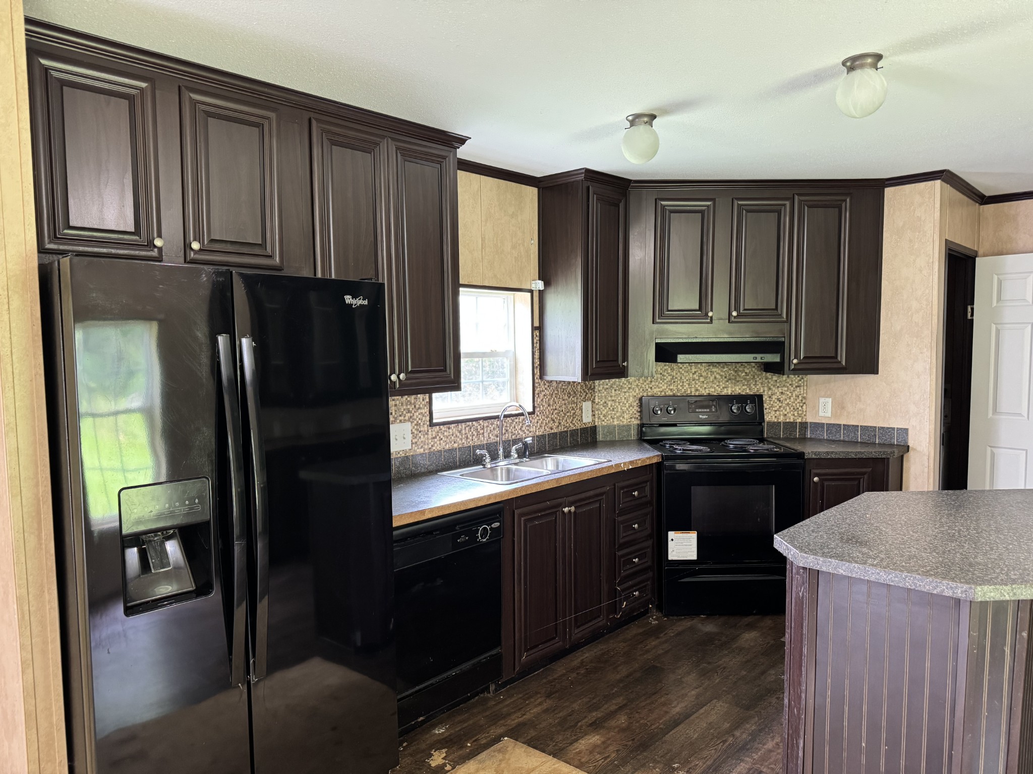 954 Normandy Road Normandy, TN 37360 - Photo 22 of 26 a kitchen with stainless steel appliances granite countertop a stove a refrigerator and a sink