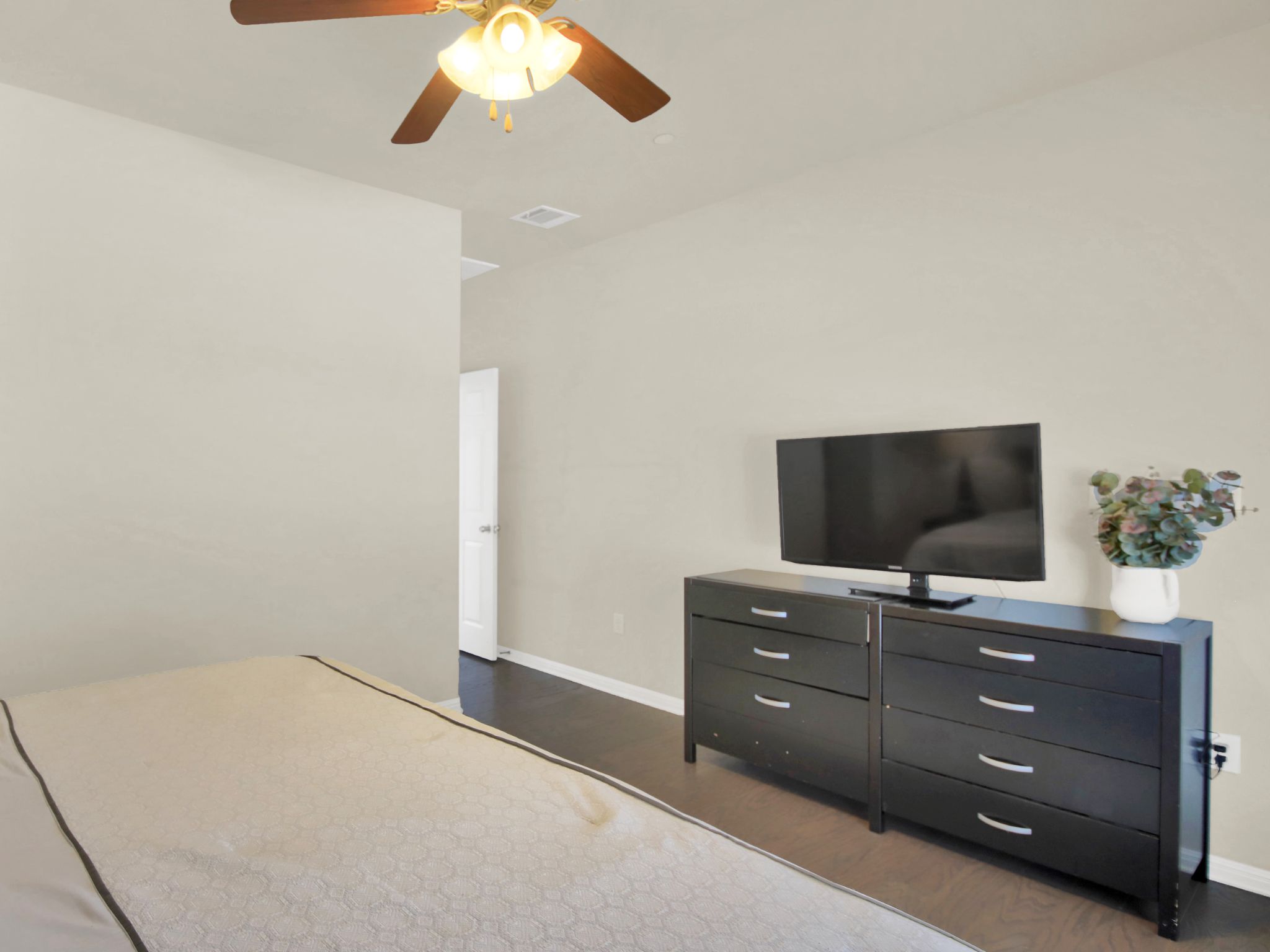 1600 Airedale Road, Unit 2601 Austin, TX 78748 - Photo 14 of 26 A restful retreat awaits in this bedroom, featuring rich hardwood flooring and a functional ceiling fan.