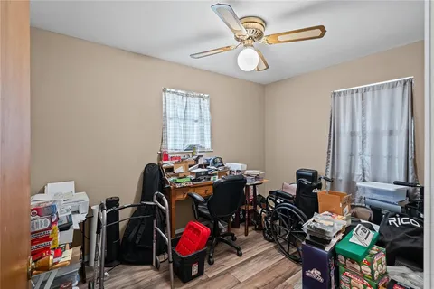 a view of a workspace with furniture and a window