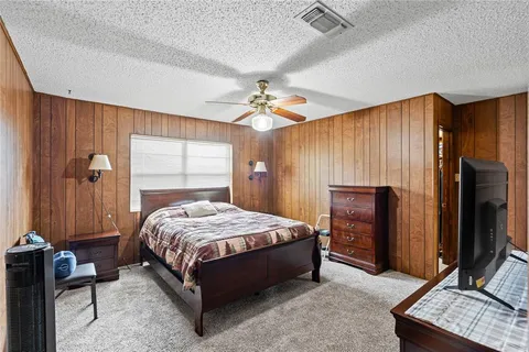 a bedroom with a bed and a flat tv screen