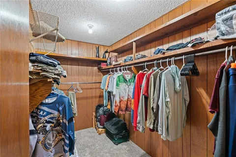 a view of walk in closet with clothes