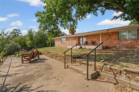 front view of a house with a large tree