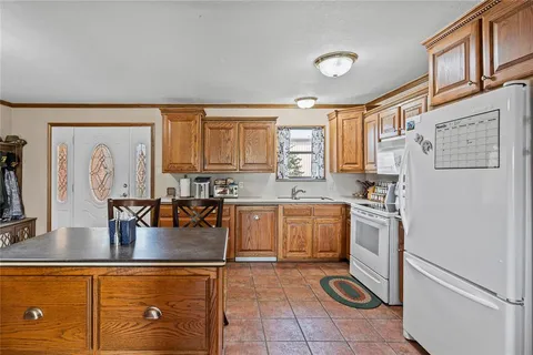 a kitchen with stainless steel appliances granite countertop a refrigerator sink and stove