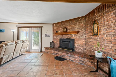 a living room with furniture a rug and a fireplace