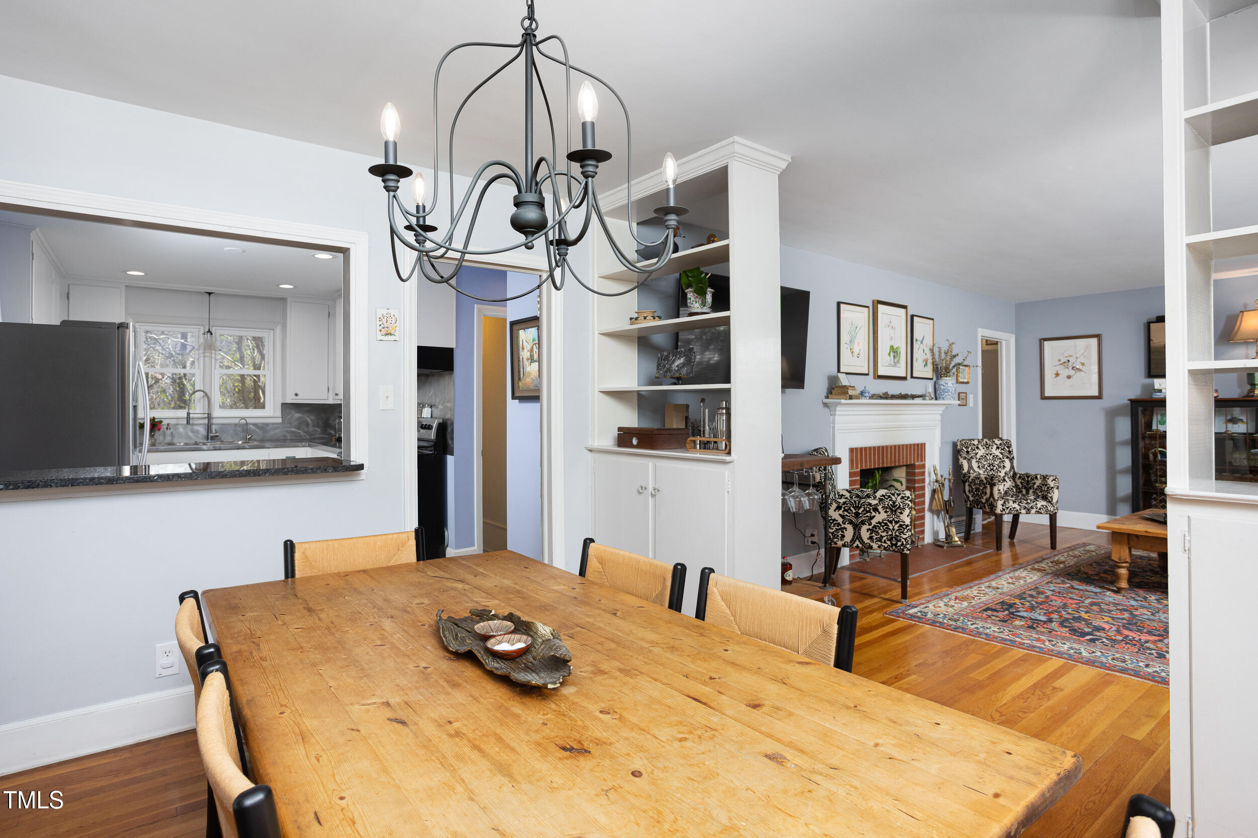 4605 Erwin Road Durham, NC 27705 - Photo 15 of 54 a kitchen with stainless steel appliances kitchen island granite countertop a table and chairs in it