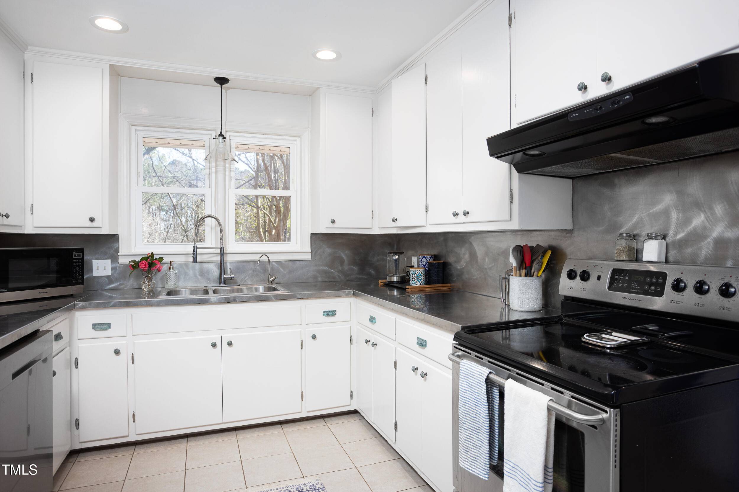 4605 Erwin Road Durham, NC 27705 - Photo 18 of 54 a kitchen with granite countertop a sink a stove and cabinets