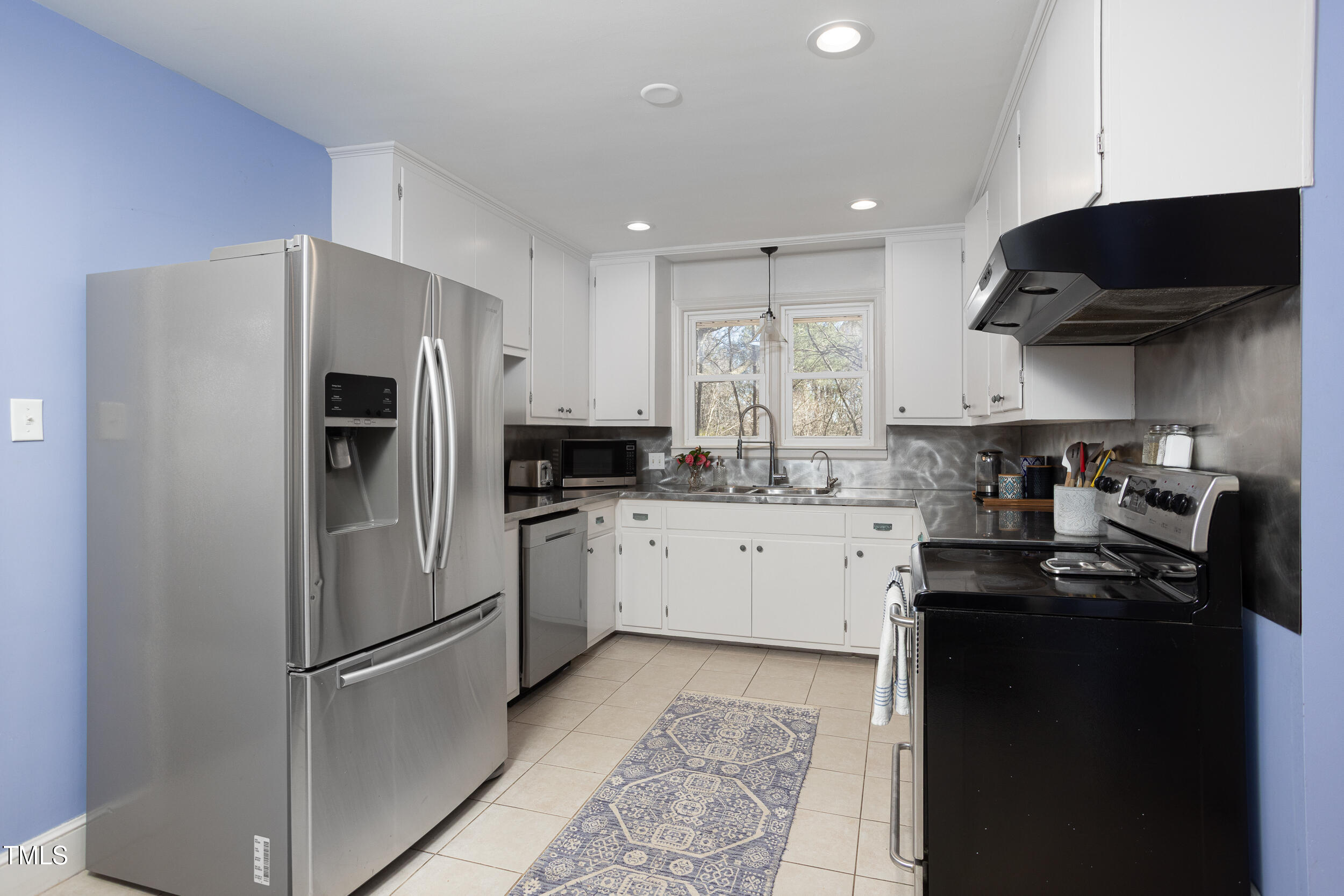 4605 Erwin Road Durham, NC 27705 - Photo 20 of 54 a kitchen with a refrigerator a sink and cabinets