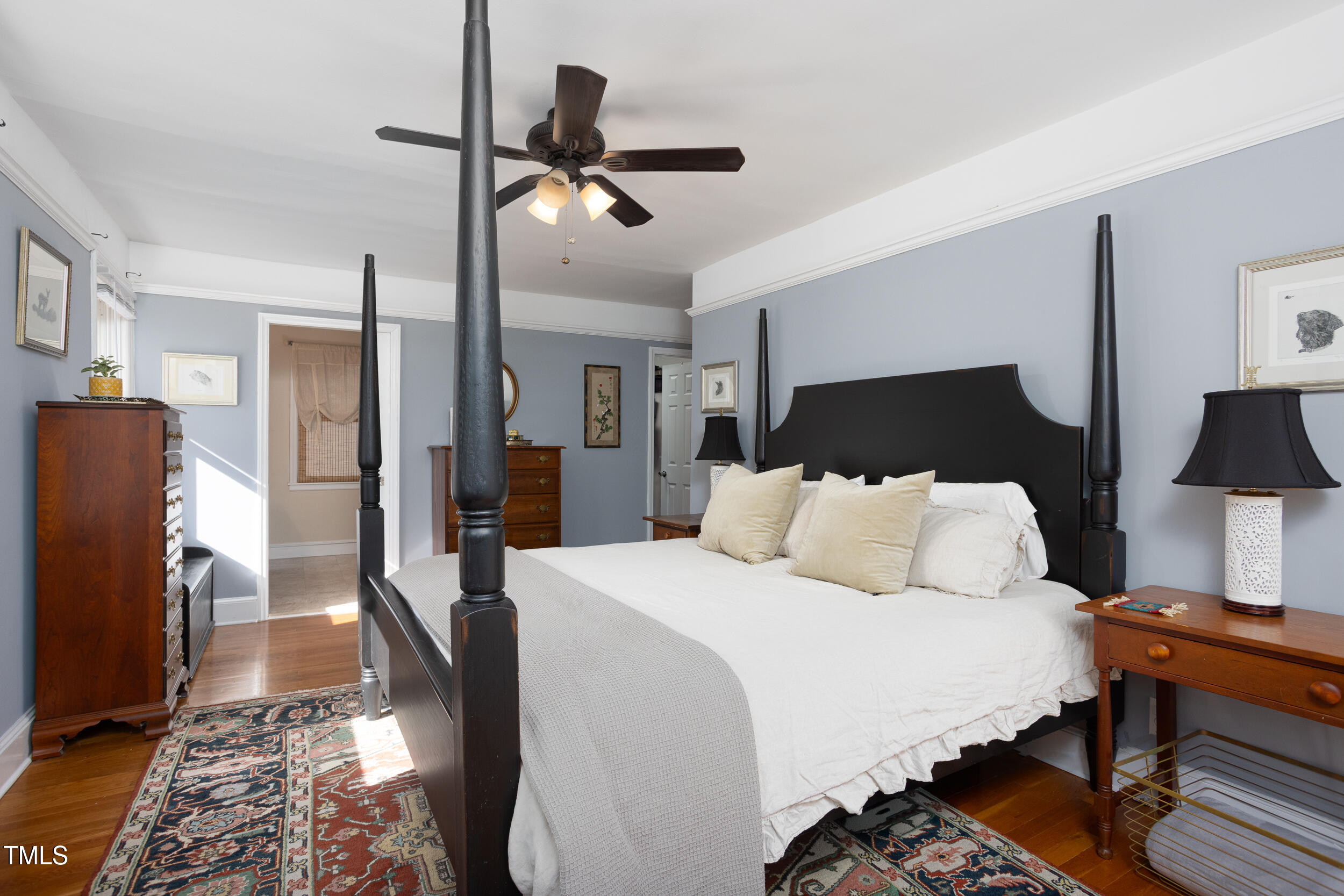 4605 Erwin Road Durham, NC 27705 - Photo 22 of 54 a spacious bedroom with a bed and a chandelier