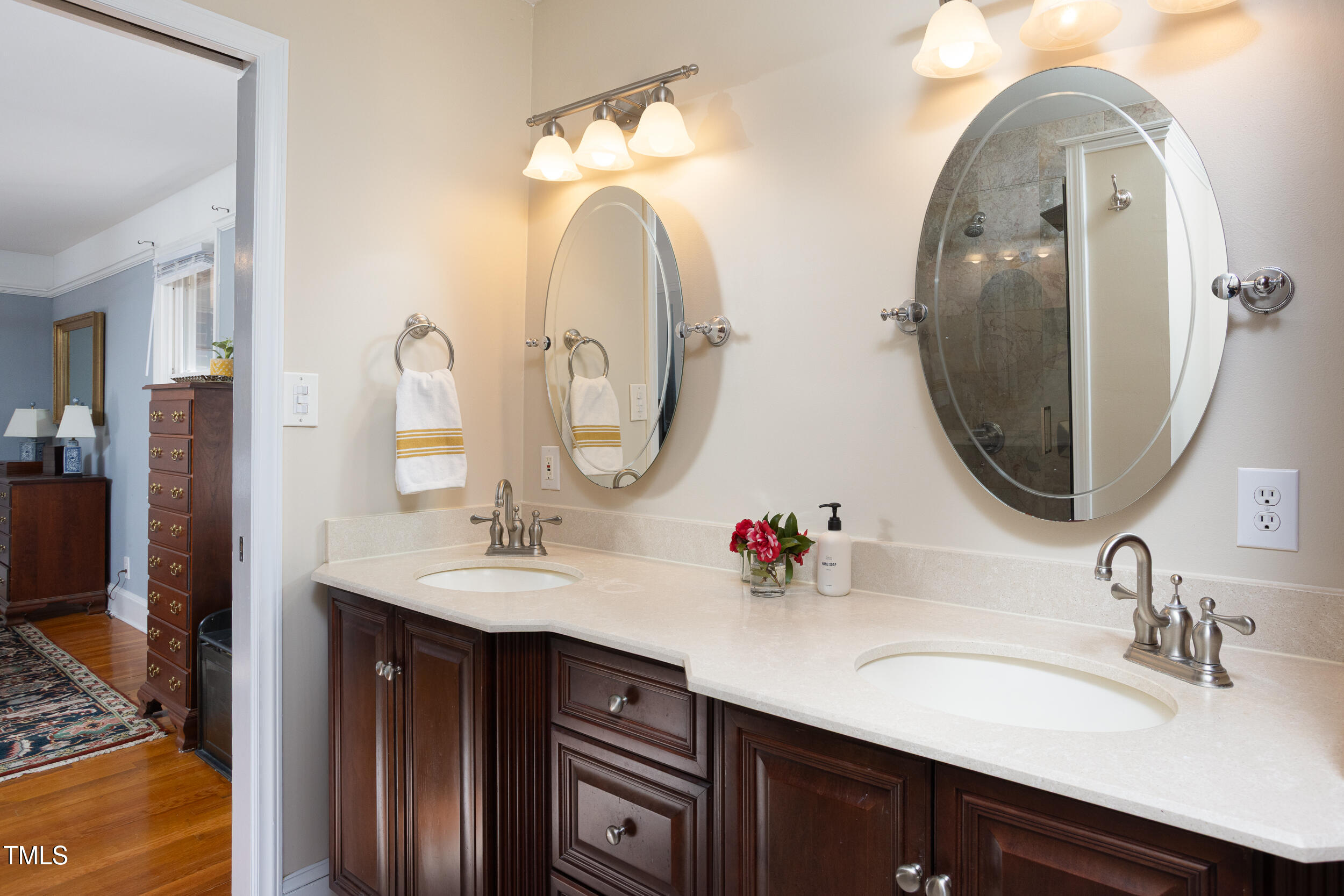 4605 Erwin Road Durham, NC 27705 - Photo 26 of 54 a bathroom with double vanity sinks and a mirror
