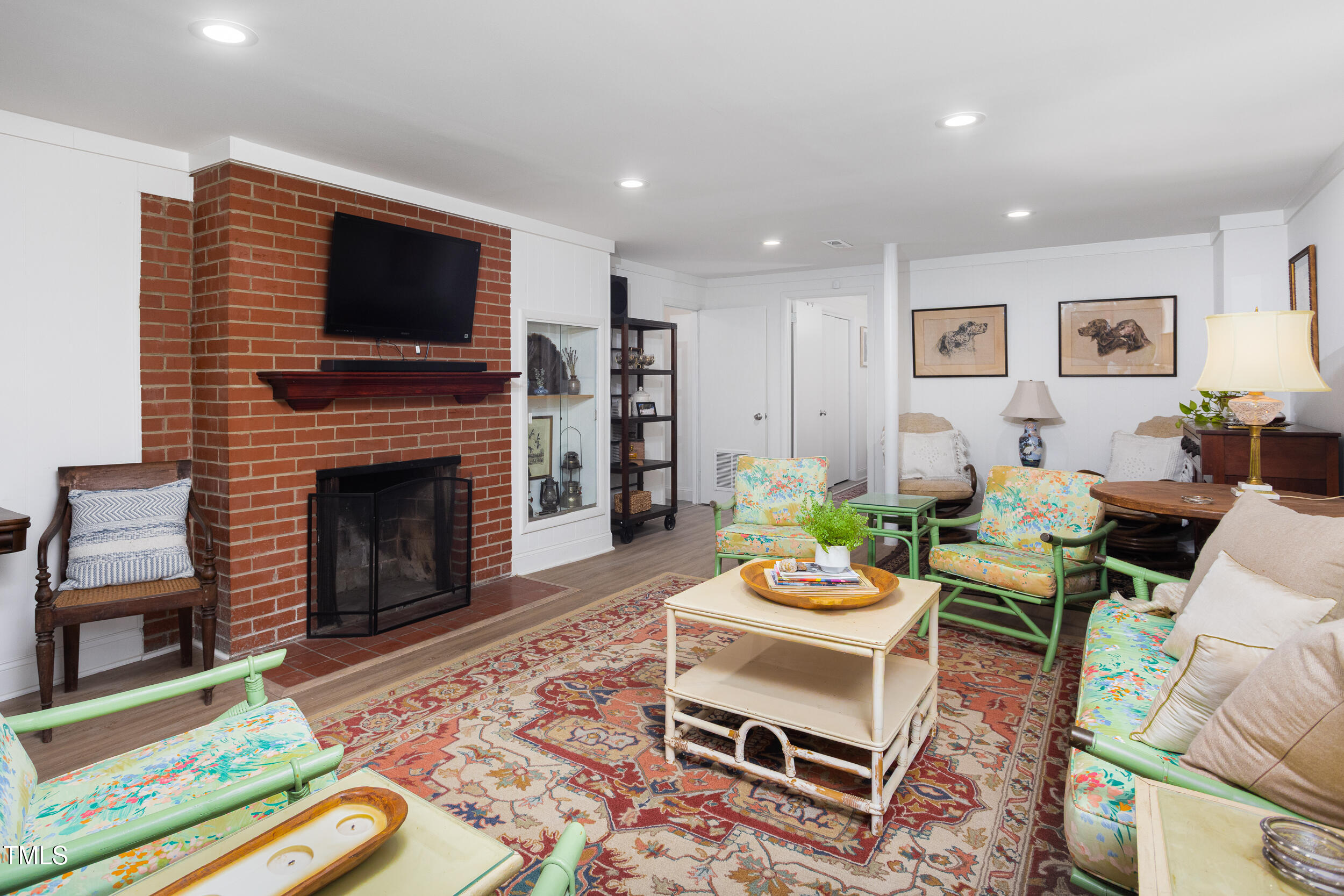 4605 Erwin Road Durham, NC 27705 - Photo 34 of 54 a living room with furniture a flat screen tv and a fireplace
