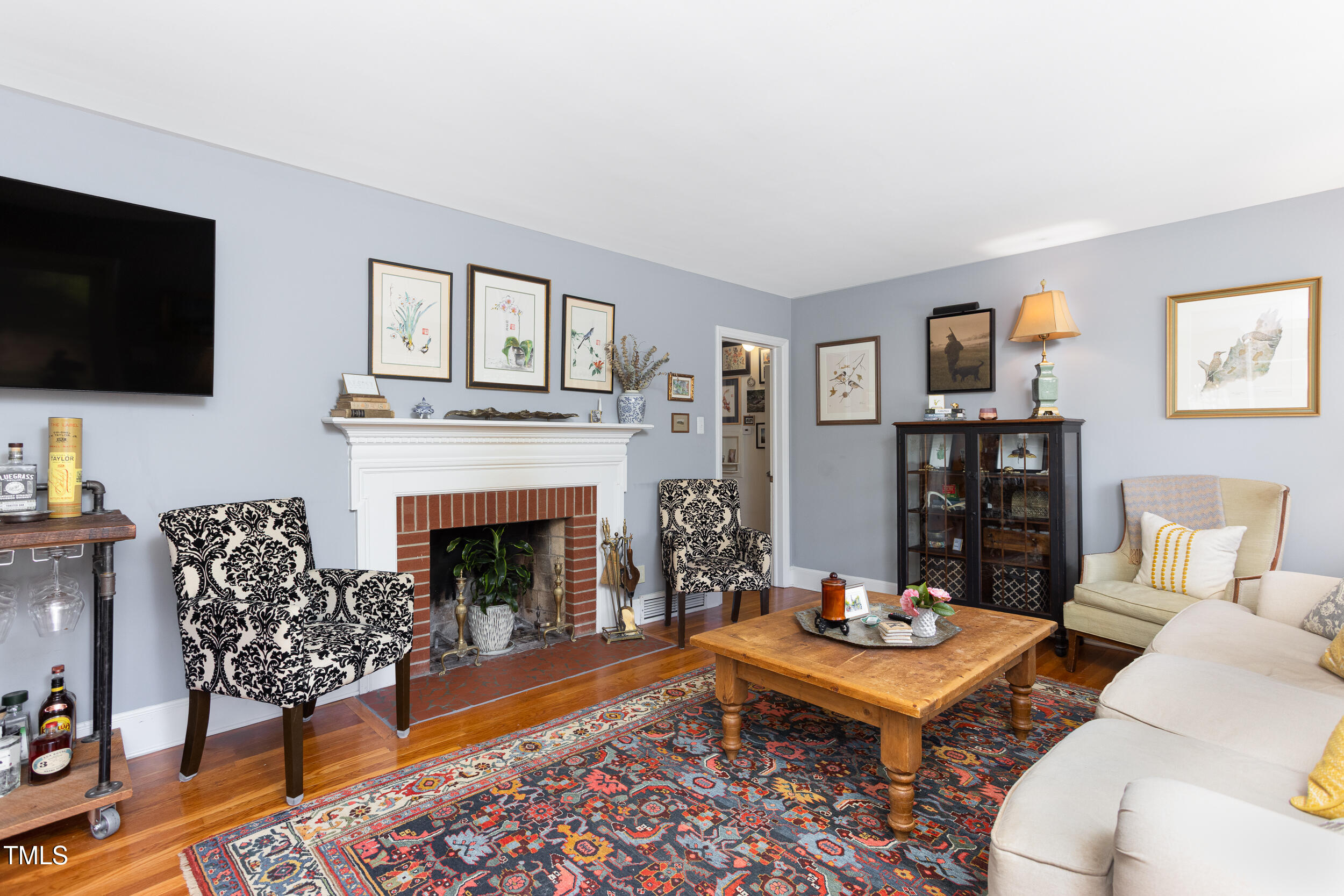 4605 Erwin Road Durham, NC 27705 - Photo 5 of 54 a living room with furniture a flat screen tv and a fireplace