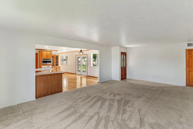 a view of a kitchen with refrigerator and a stove top oven