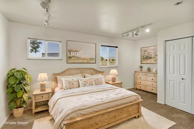 a bedroom with a bed and paintings on the wall