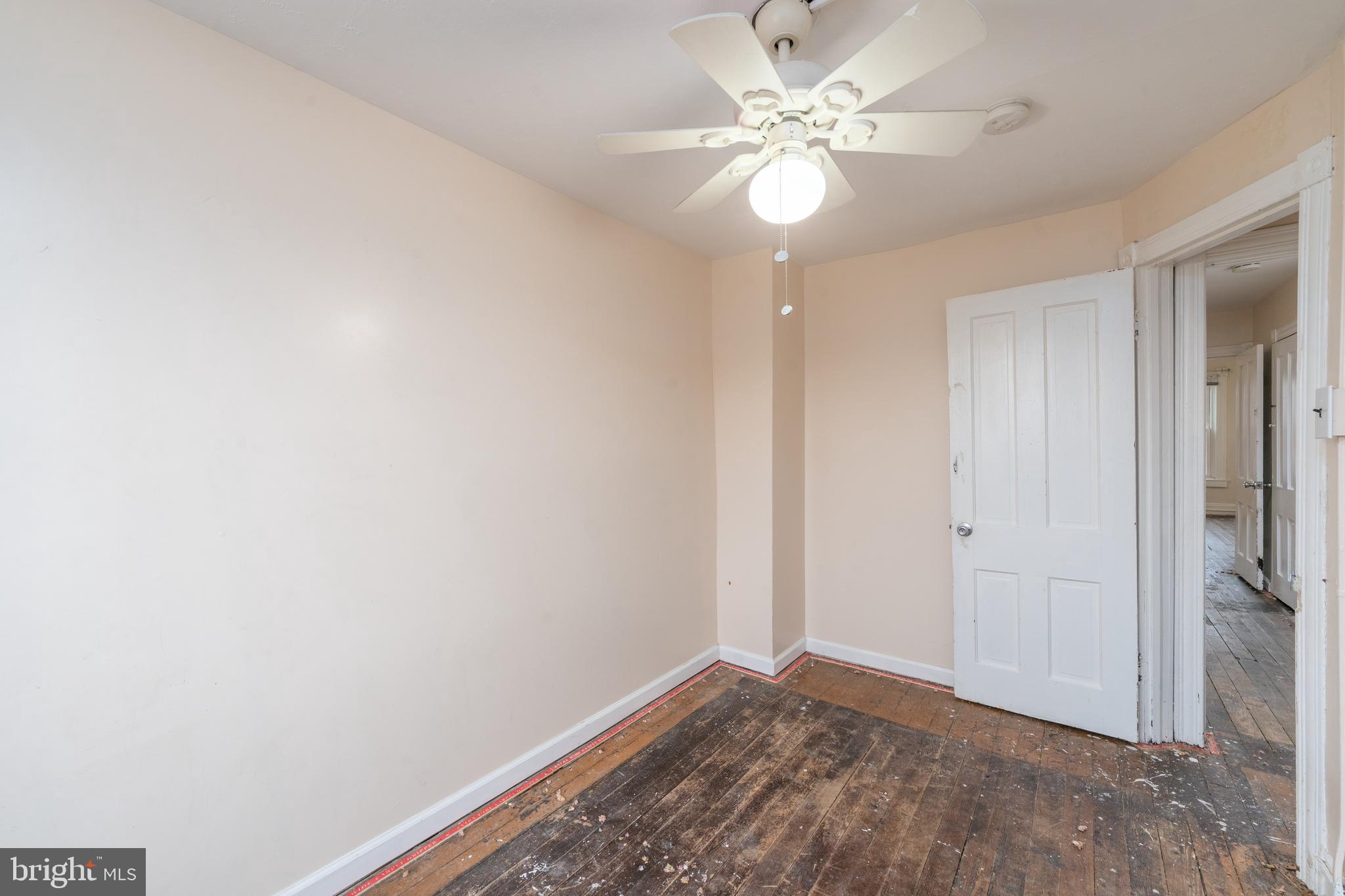 514 Brunswick Street Baltimore, MD 21223 - Photo 13 of 26 a view of an empty room with a fan