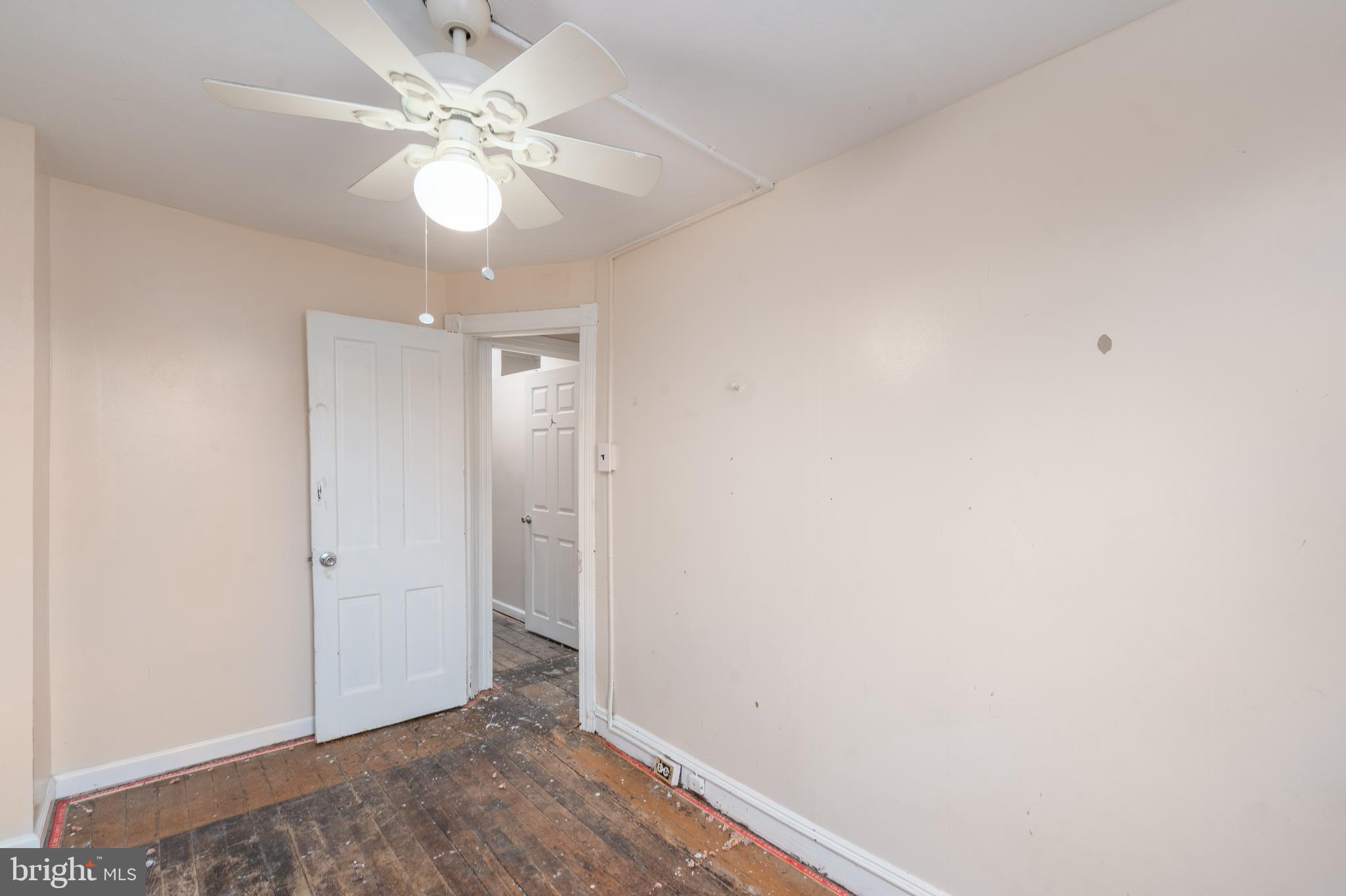 514 Brunswick Street Baltimore, MD 21223 - Photo 14 of 26 an empty room with chandelier fan and closet area