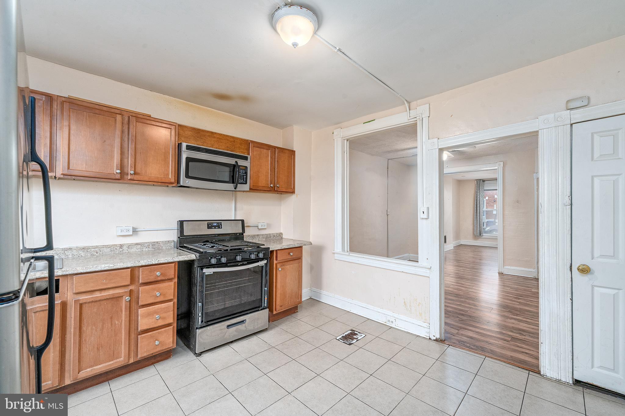514 Brunswick Street Baltimore, MD 21223 - Photo 9 of 26 a kitchen with stainless steel appliances granite countertop a stove and a sink
