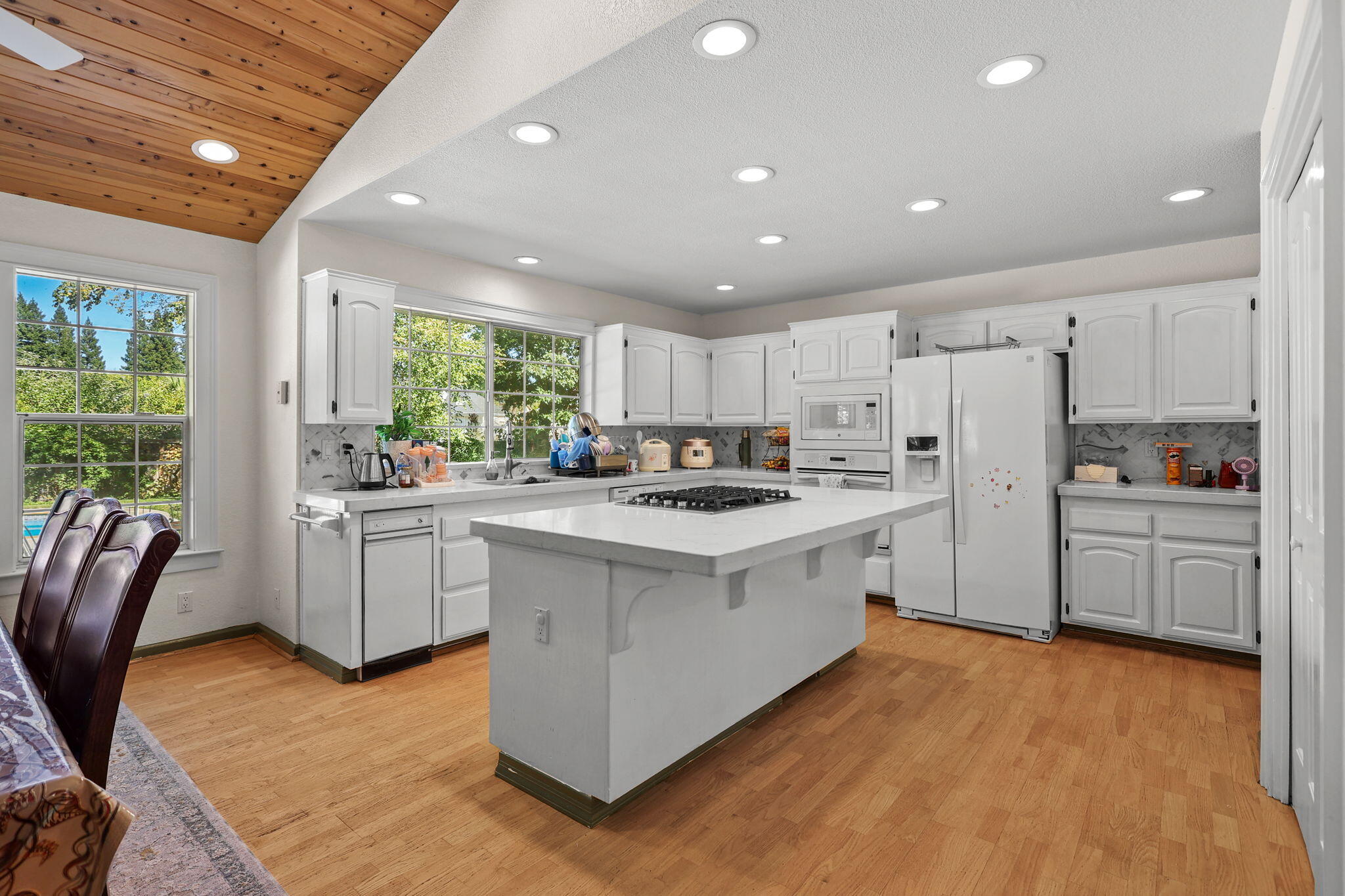 2366 Templeton Drive Redding, CA 96002 - Photo 11 of 54 a kitchen with white cabinets and white appliances