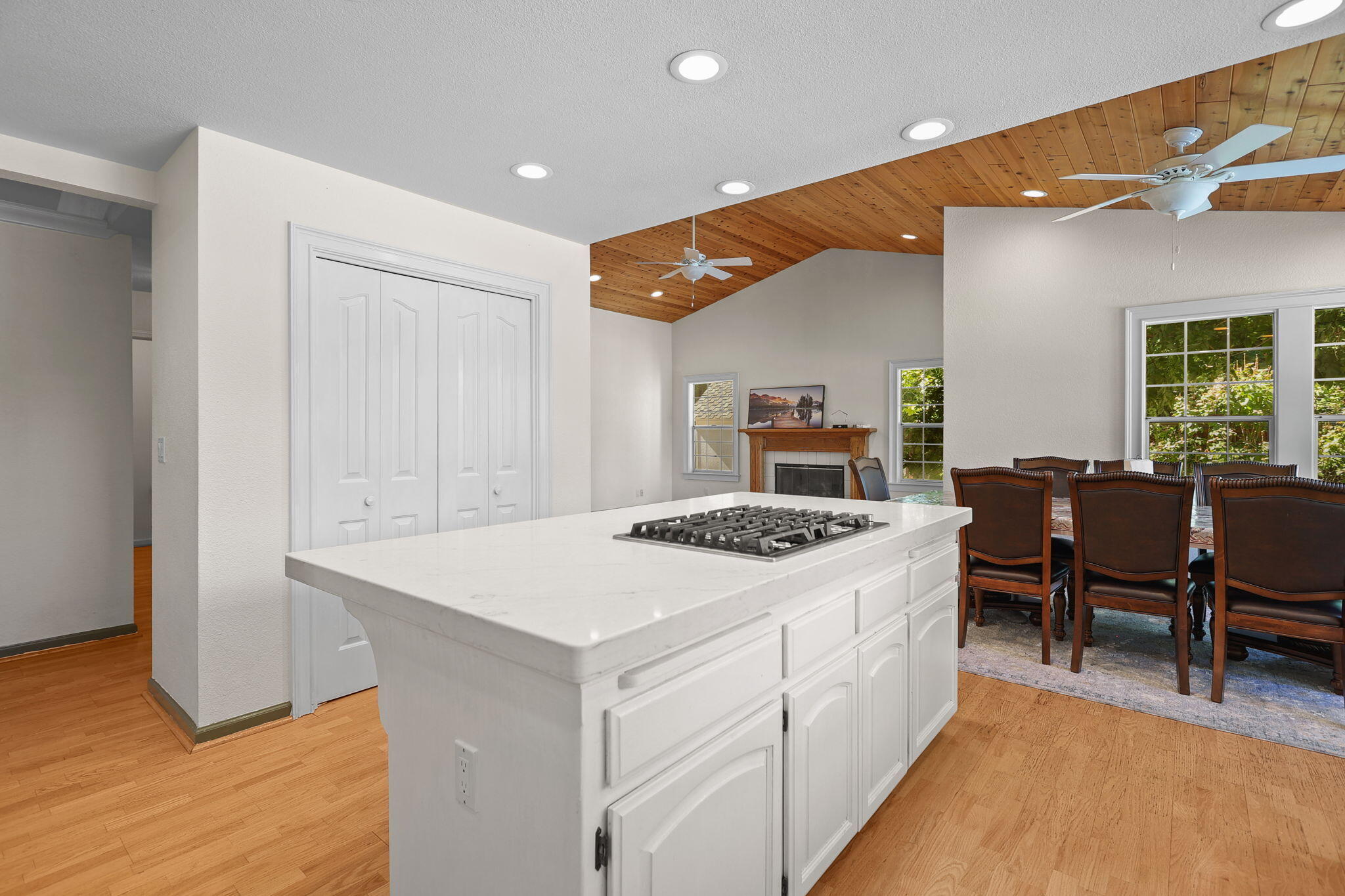 2366 Templeton Drive Redding, CA 96002 - Photo 13 of 54 a view of kitchen island with stainless steel appliances wooden floor dining table and chairs