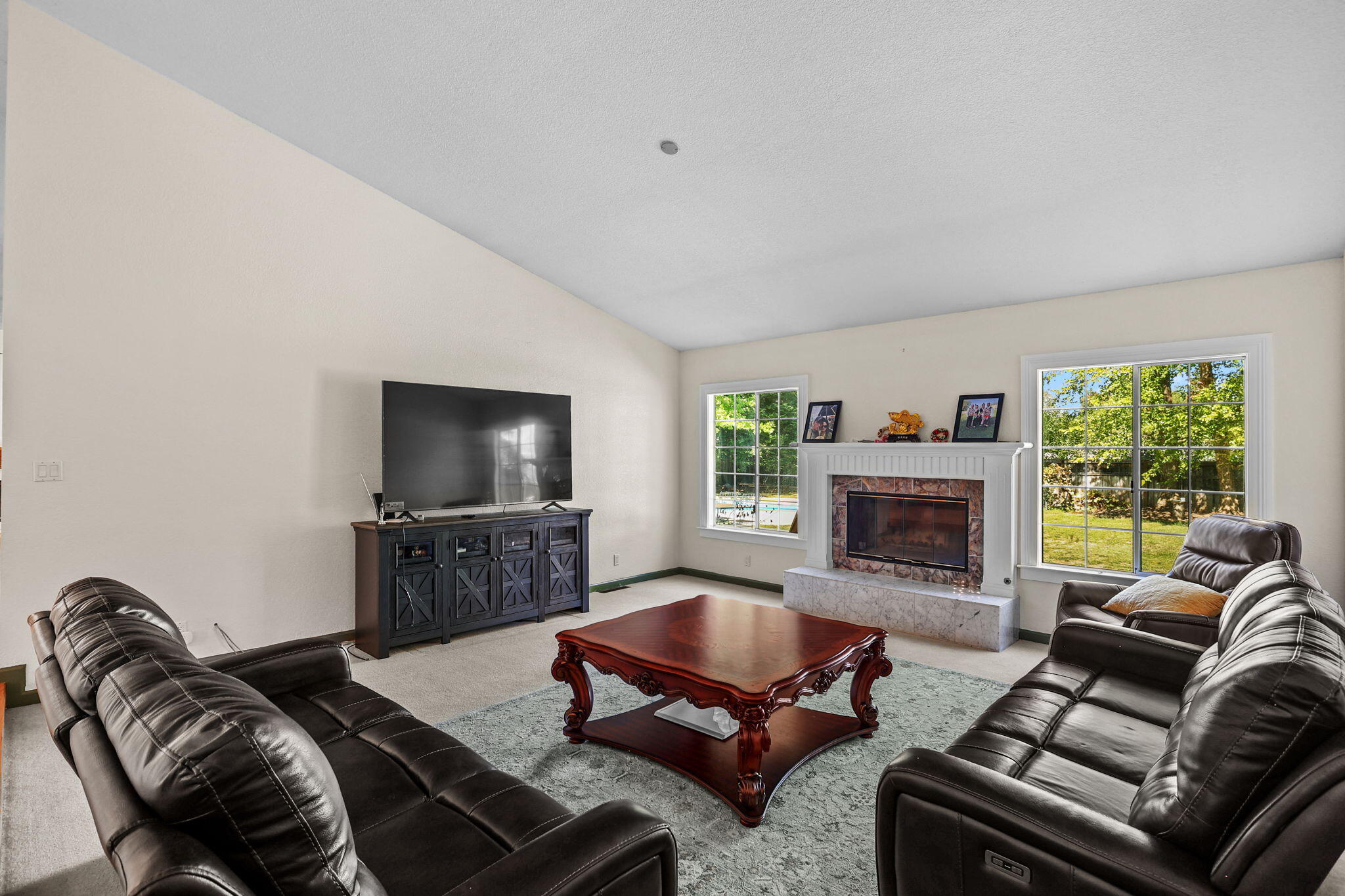 2366 Templeton Drive Redding, CA 96002 - Photo 4 of 54 a living room with furniture flat screen tv and a fireplace
