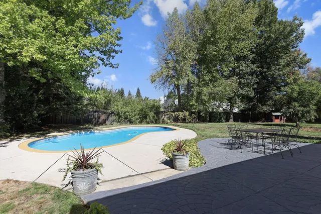 a view of a swimming pool with back yard
