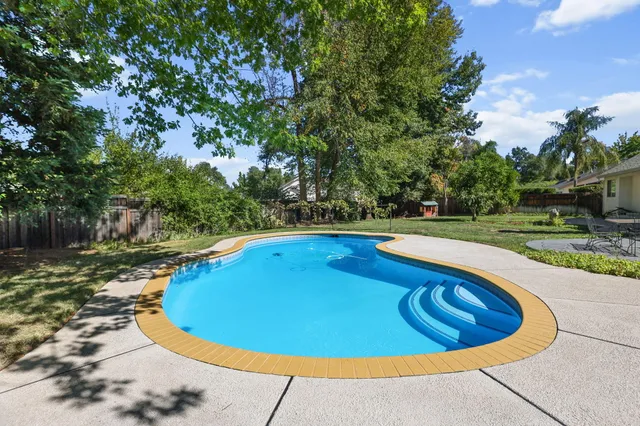 a view of a house with swimming pool and a porch