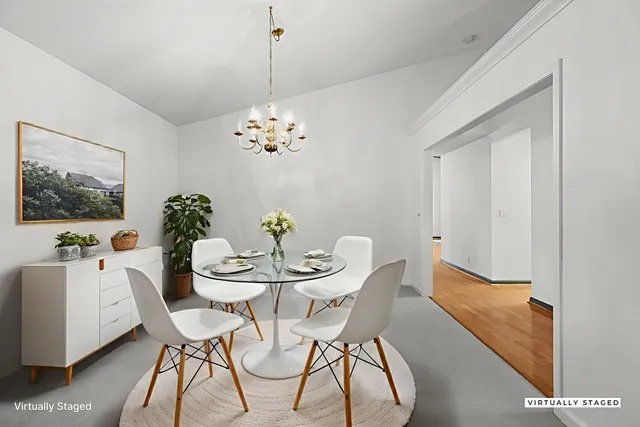 a view of a dining room with furniture and chandelier