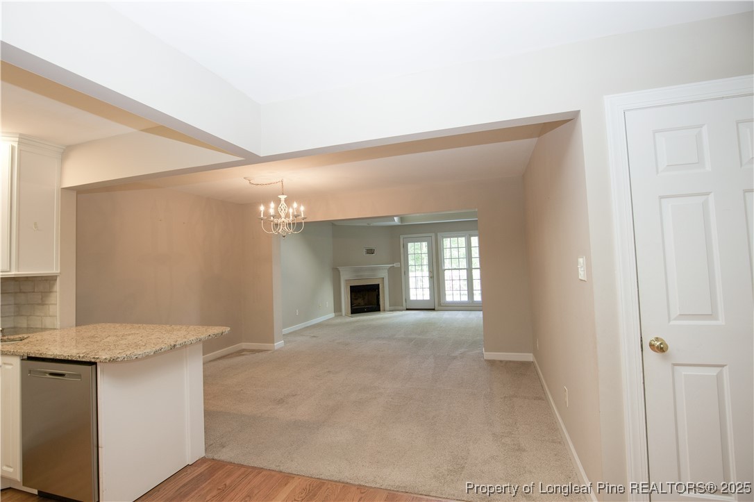175 Knoll Road Southern Pines, NC 28387 - Photo 4 of 50 a view of an empty room with a fireplace and a window