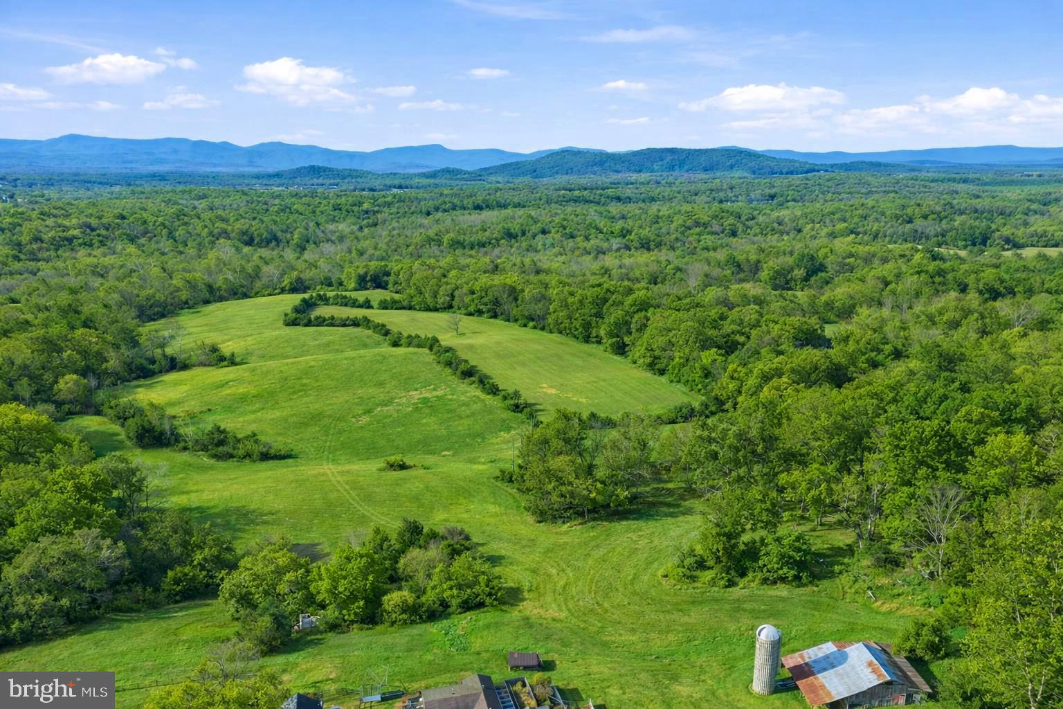 Lot A Trasara Road Rapidan, VA 22733 - Photo 16 of 17 a view of a lush green outdoor space with a large pool and mountain view