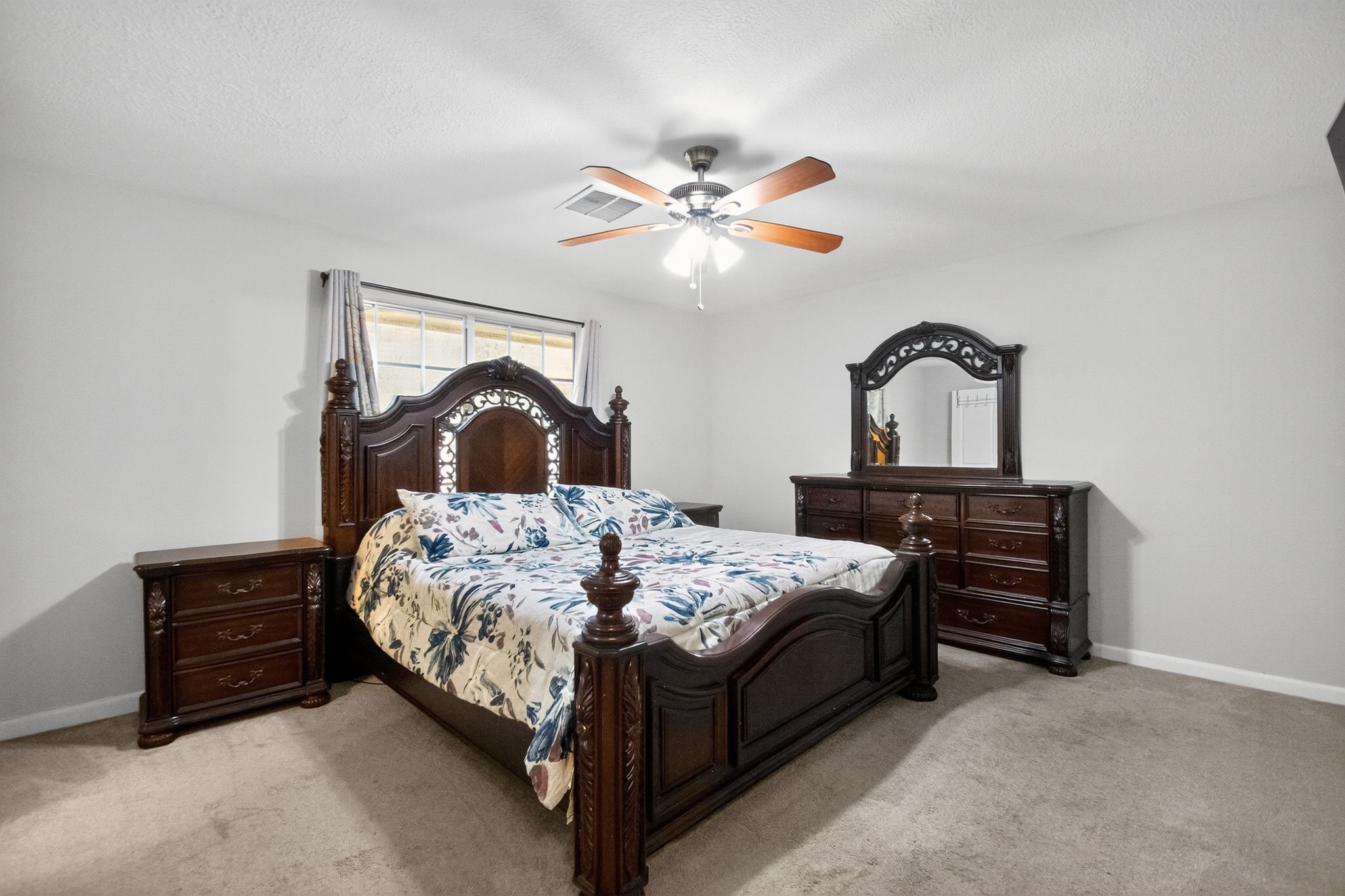2514 Creekleaf Road Houston, TX 77068 - Photo 12 of 31 a bedroom with a bed and a chandelier