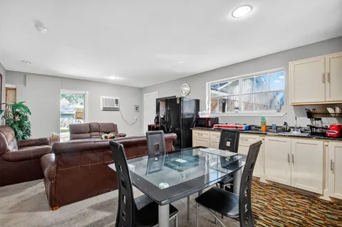 a living room with furniture a dining table and kitchen view