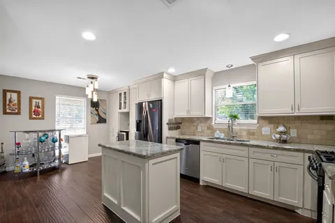 a kitchen with a sink stove and cabinets