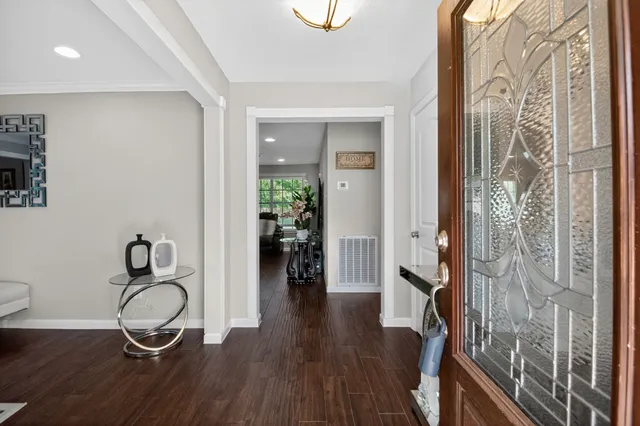 a dining room with wooden floor and furniture
