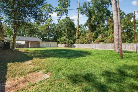 a view of house with backyard