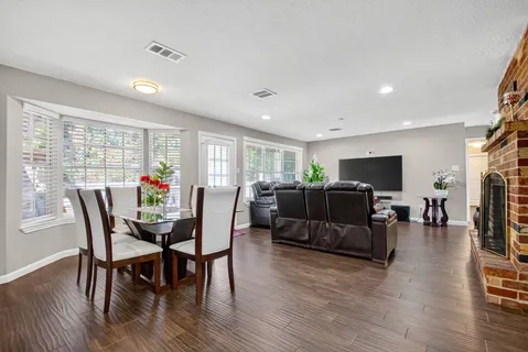 a view of a dining room with furniture window and wooden floor