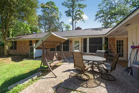 a view of a house with backyard porch and sitting area