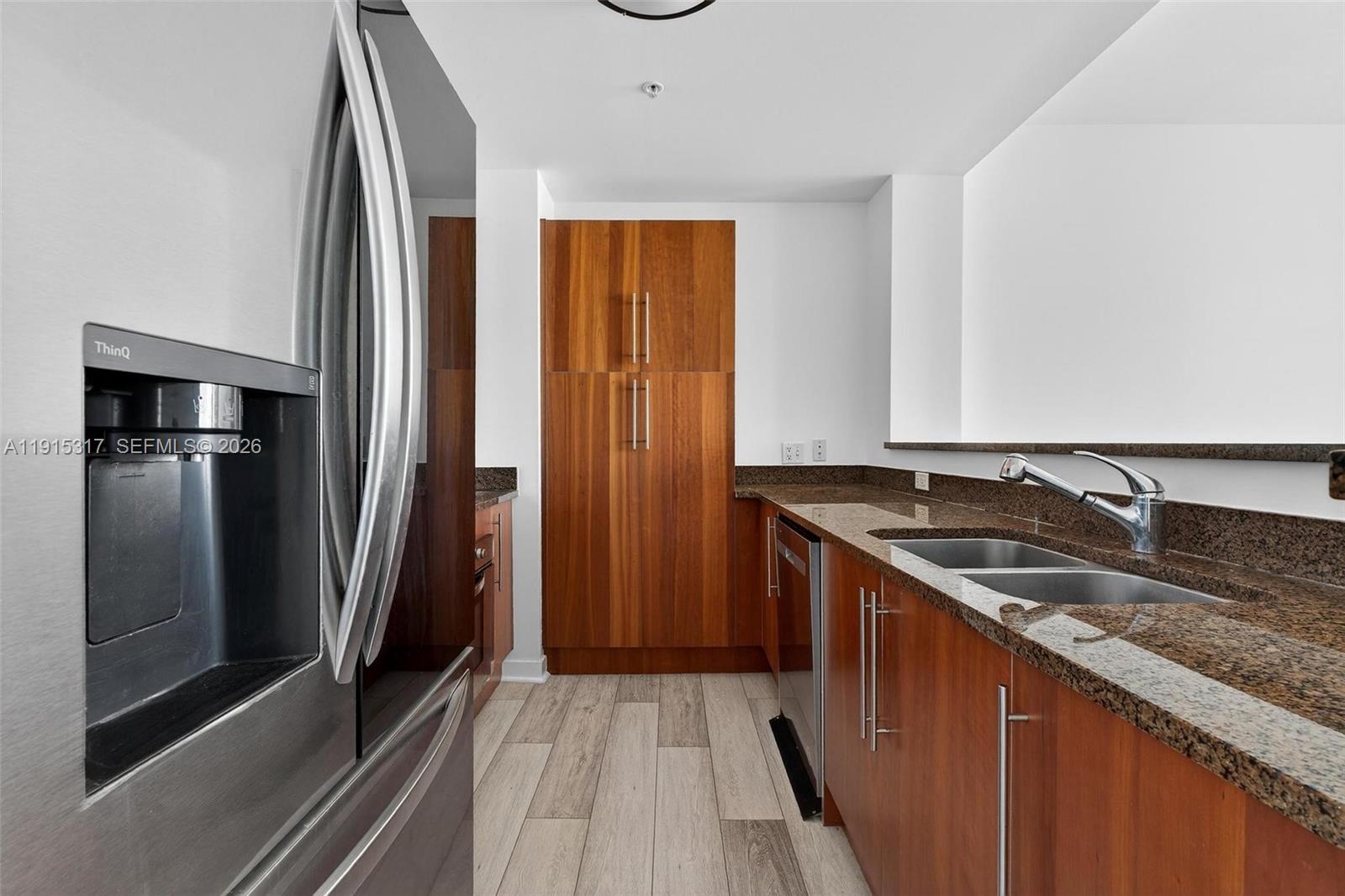 300 South Biscayne Boulevard, Unit T2407 Miami, FL 33131 - Photo 11 of 39 a kitchen with granite countertop stainless steel appliances a sink and a refrigerator