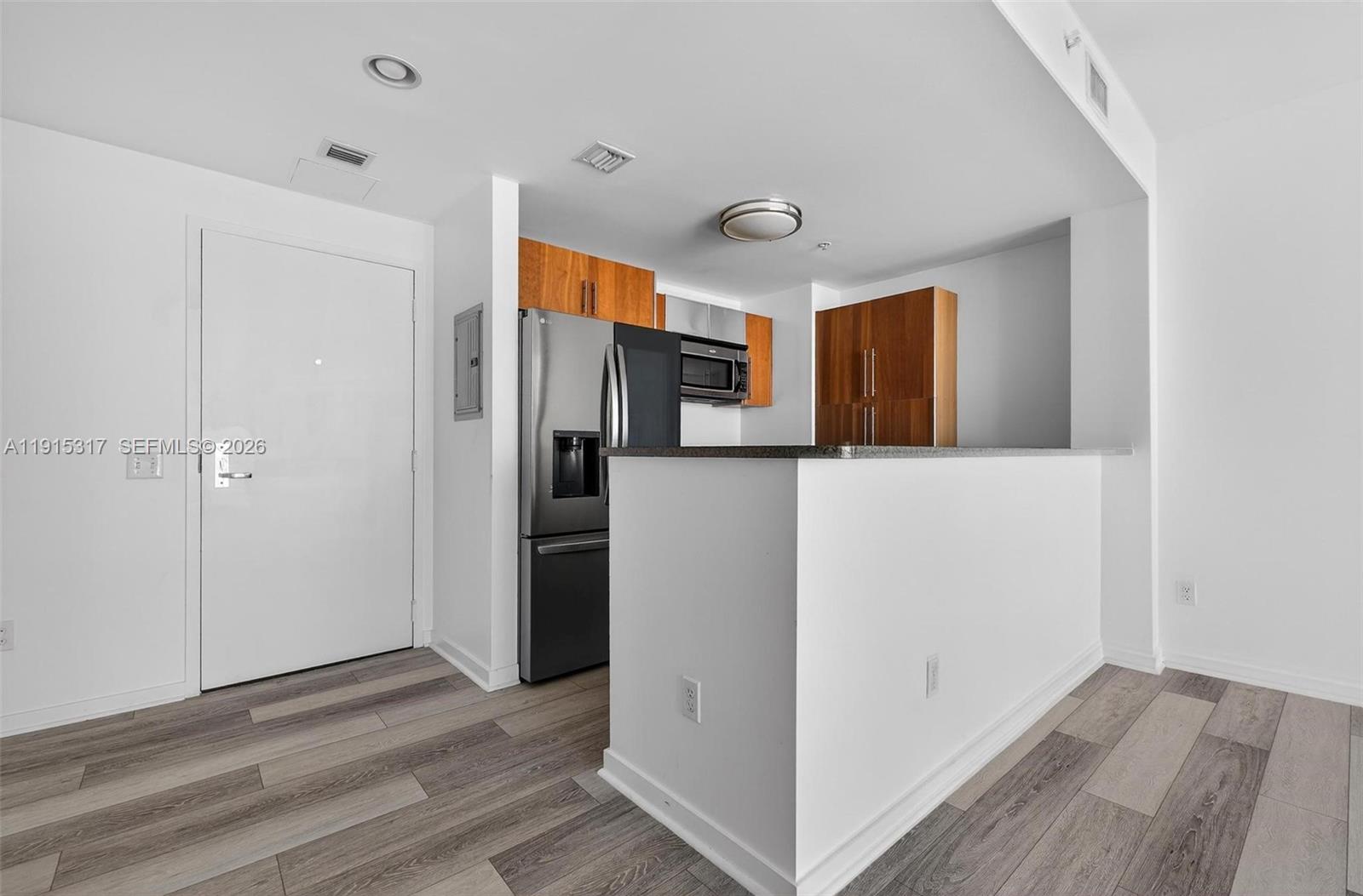 300 South Biscayne Boulevard, Unit T2407 Miami, FL 33131 - Photo 15 of 39 a view of a kitchen with refrigerator and wooden floor