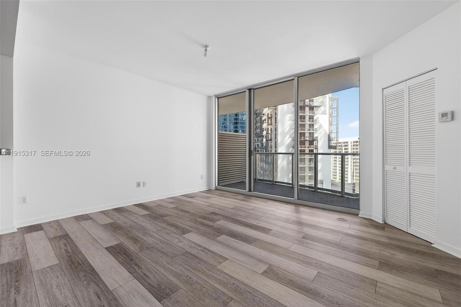300 South Biscayne Boulevard, Unit T2407 Miami, FL 33131 - Photo 16 of 39 a view of empty room with wooden floor and fan